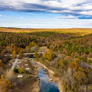 Visit Tenkiller State Park during the peak of fall foliage season in Gore to witness striking fall hues.