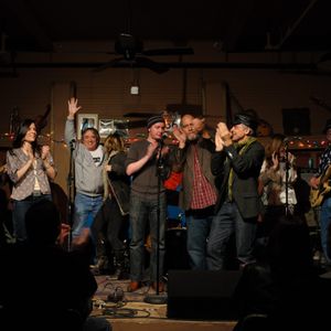 Performing artists gather onstage at The Blue Door 19th anniversary concert in 2012