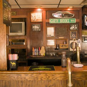 Small pieces of memorabilia line the bar at the former Willies Saloon (now State Room Bar) in Stillwater, where Garth Brooks played some of his first public performances.