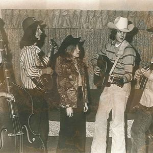 Vince Gill (wearing a cowboy hat) and his band, The Bluegrass Revue, practice in his living room in Oklahoma City.
