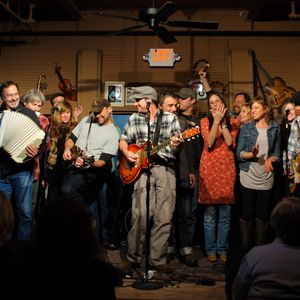 Performing artists gather on stage at The Blue Door's 2012 Woody Guthrie tribute concert 