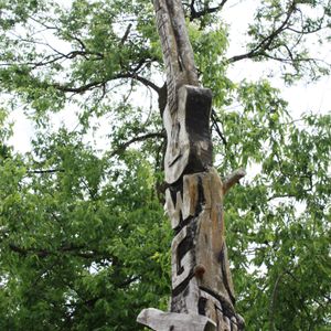 A whimsical memorial to Woody Guthrie that stands in what was formerly the yard of one of his boyhood homes.