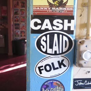 Artist stickers on an interior doorway of The Blue Door