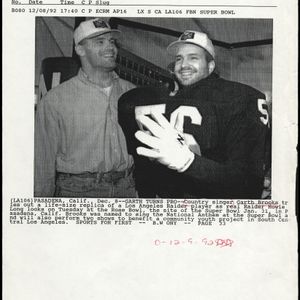 On December 8th, 1992, in preparation for the Super Bowl, Garth Brooks tries out a life-size replica of a Los Angeles Raider player while real Raider Howie Long observes.  Brooks sang the National Anthem at the Super Bowl and also performed two benefit shows in Los Angeles while there.
