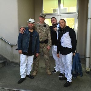 Color Me Badd poses with a member of the United States Army following their performance for soldiers and community at Camp Zama, Japan in September, 2015.