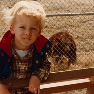 A young Ryan Tedder poses for a photo with a bear at the Tulsa Zoo.