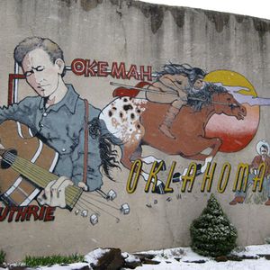 Woody Guthrie has remained popular decades after his death.  This mural was painted by DeAnna Wilson in his hometown of Okemah in 1994.