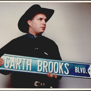 Garth Brooks holds the autographed Yukon street sign named his honor.