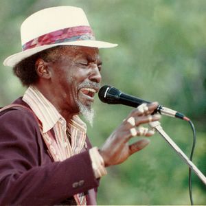 D.C. Minner performs at his home in Rentiesville.