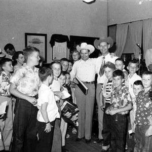 In the cowboy hats, Johnnie Lee Wills and Leon McAuliffe. The book near Johnnie Lee's right knee is by Eddie Alkire, a Hawaiian steel guitar player. 
