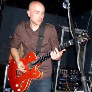 Trent Bell playing guitar during the Chainsaw Kittens performance at the first annual Norman Music Festival in 2008