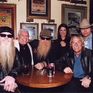 Kellie Coffey pictured with ZZ top and Dwight Yoakam at the Hard Rock Cafe in Nashville, Tennessee in 2002