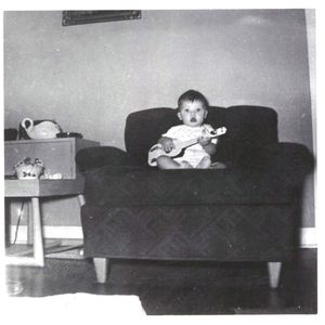 Ronnie Dunn at 6 months old with his first guitar.