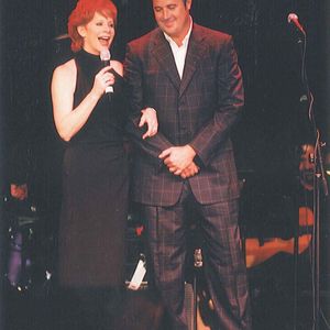 Vince Gill performs "The Heart Won't Lie" with Reba McEntire at a benefit concert. 