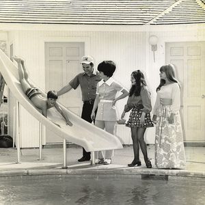 Conway Twitty and his wife Mickey watch their son, Jimmy, slide into the pool at the family's home in Moore, Oklahoma.
