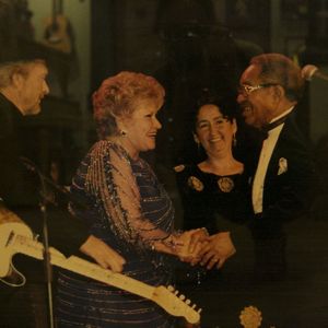 Patti Page, with Merle Haggard behind her, shakes hands after a performance at the Oklahoma Music Hall of Fame in Muskogee.