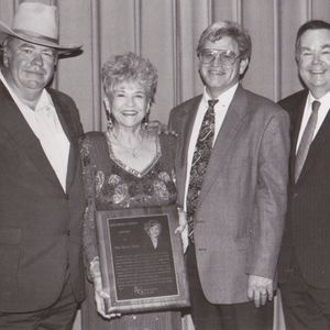 Mae Boren Axton stands with her sons Hoyt and David at her sides and her nephew David Boren on the far right.