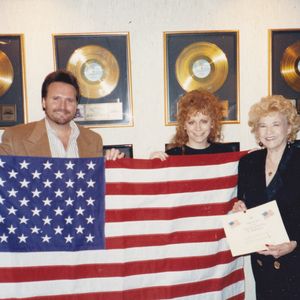 Mae Boren Axton presents a flag to fellow Oklahoman Reba McEntire that flew at the United States Capitol in her name.