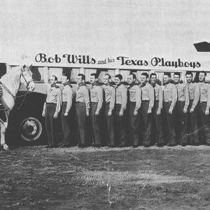 Bob Wills and the Texas Playboys with their bus. 