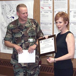 Reba McEntire holds a certificate of appreciation that was presented to her by US Army Lt. Col. Joseph Brown, Joint Task Force (JTF) Village Commander, in June 1999.