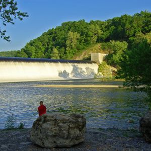 An angler enjoys fishing below the spillway at Spavinaw Area at Grand Lake State Park.