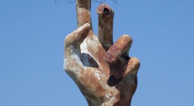 Butterfly on a Giant Metal Hand