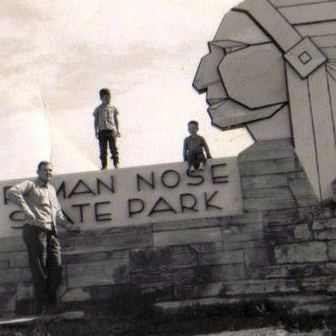 A vintage family photo taken at the entrance to Roman Nose State Park where families still pose today.