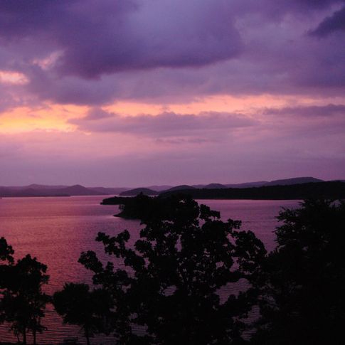 A romantic sunrise over Broken Bow Lake near Beavers Bend State Park.