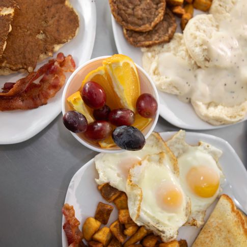 Start your day with a sunny-side-up breakfast plate including all your favorite sides like fruit and toast.