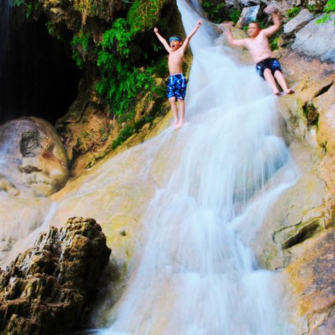 Kids can explore the 77-foot waterfall and swim in natural pools at Turner Falls Park in Davis.