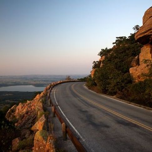 The Wichita Mountains Scenic Byway in southwest Oklahoma allows visitors to drive right to the top of Mount Scott where they can park and take in the panoramic views over the rugged Wichita Mountains.
