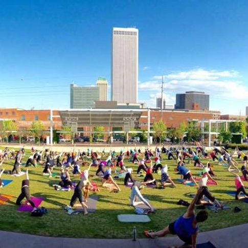 Gather outdoors in Tulsa districts for activities like yoga held on the Guthrie Green in the Tulsa Arts District.