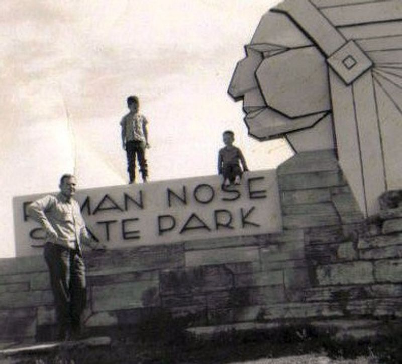 A vintage family photo taken at the entrance to Roman Nose State Park where families still pose today.
