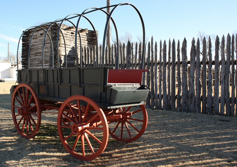 A six-mule wagon stands near the stockade fence at the Fort Supply Historic Site in western Oklahoma.  Fort Supply served as a base for General Philip Sheridan's campaigns against tribes in the Southern Plains region in 1868.