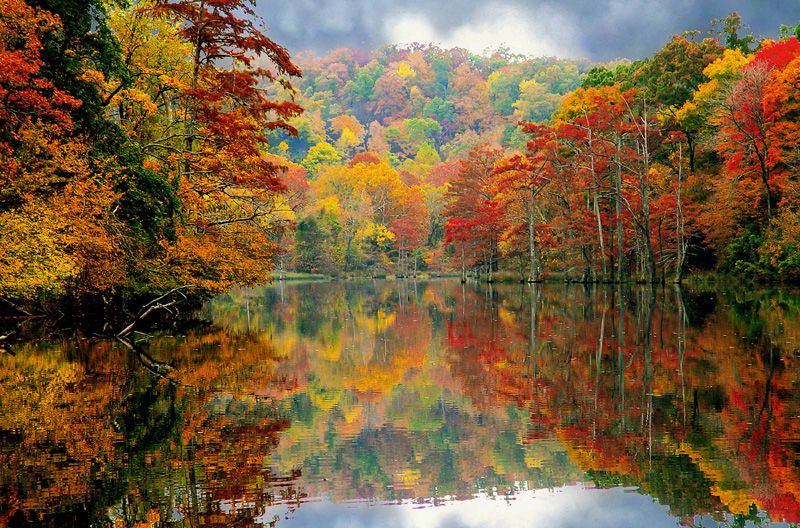 Beavers Bend State Park puts on a majestic show as its spicy fall colors reflect on the smooth-as-glass surface of the water.