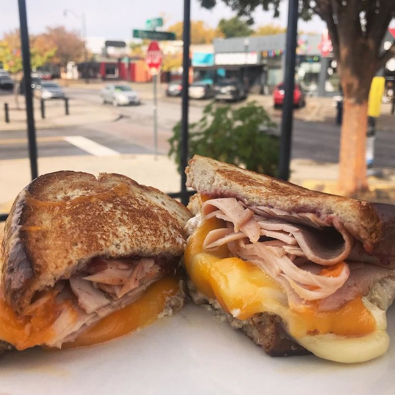 Dive into the Tryptophantastic at Oklahoma City's The Mule each November, featuring wheat bread, turkey, cheddar, gruyere, thyme aioli, cranberry sauce and sausage stuffing.