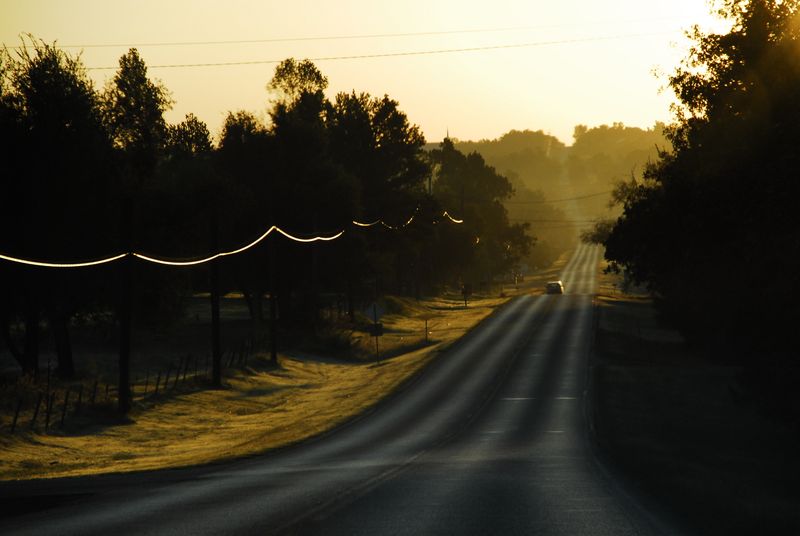 A rural stretch of Route 66 glows at sunset.