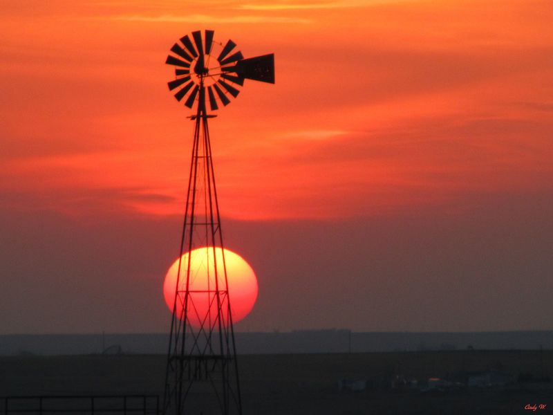 A cloudy sunset in the Oklahoma panhandle provided an awesome display of the sun as it was setting next to a windmill in Texas County near Guymon.
