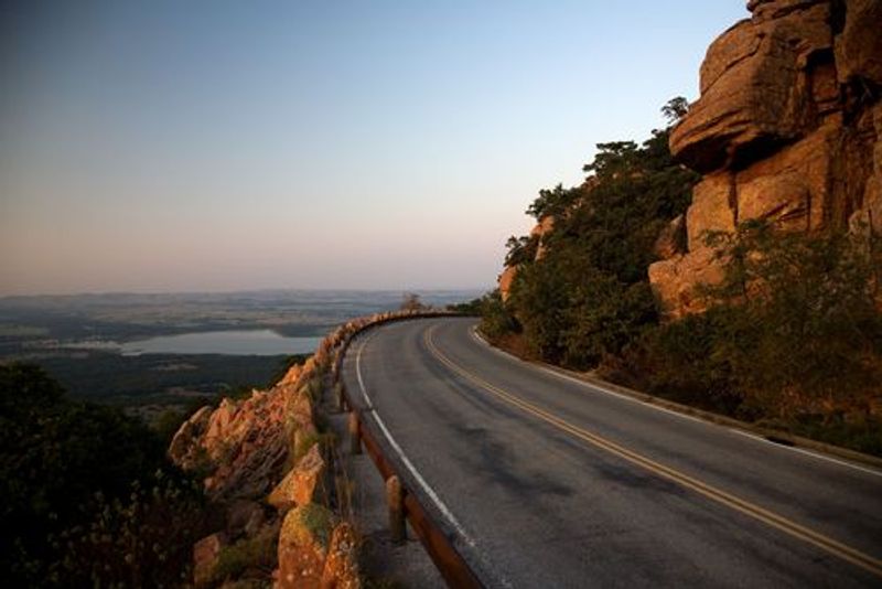 The Wichita Mountains Scenic Byway in southwest Oklahoma allows visitors to drive right to the top of Mount Scott where they can park and take in the panoramic views over the rugged Wichita Mountains.