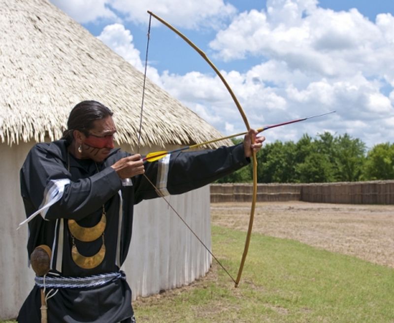 A Chickasaw re-enactor demonstrates archery techniques at the Chickasaw Cultural Center in Sulphur.