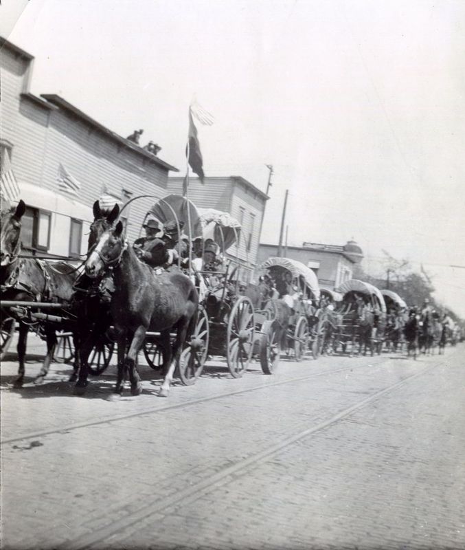 A parade of covered wagons makes its way along Oklahoma Avenue in Guthrie to celebrate Pioneer Day in April 1912.  The event, now known as 89ers Day, celebrates the heritage of the pioneers who made the land run into Guthrie on April 22, 1889.