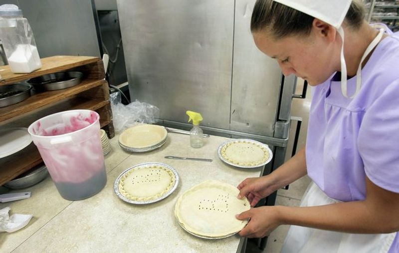 Amish woman preparing fresh baked goods at Nettie Ann's Bakery, part of the Amish Cheese House in Chouteau.