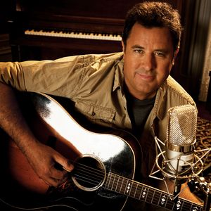 Vince Gill poses with his guitar for a promotional photo in 2011.