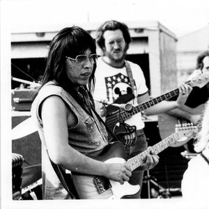 Jesse Ed Davis, left, with Gary Gilmore and JJ Cale in background, performing with Leon Russell at the Tulsa Fairgrounds Racetrack on June 18, 1972.