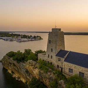 Watch an iconic Oklahoma sunset from the historic Tucker Tower at Lake Murray State Park.