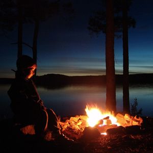 A 5-year-old is deep in thought while staring at the campfire at McGee Creek State Park near Atoka in southeastern Oklahoma.