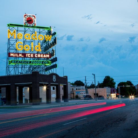 The circa-1939 Meadow Gold sign in Tulsa lights up the sky along Route 66.