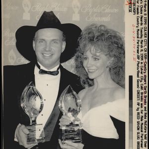 Garth Brooks and Reba McEntire hold their People's Choice Awards on March 8, 1994 in Culver City, California. Brooks won for Male Musical Performer and McEntire for Female Country Musical Performer. 