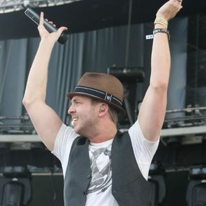 Frontman Ryan Tedder of OneRepublic performing on stage in 2009.