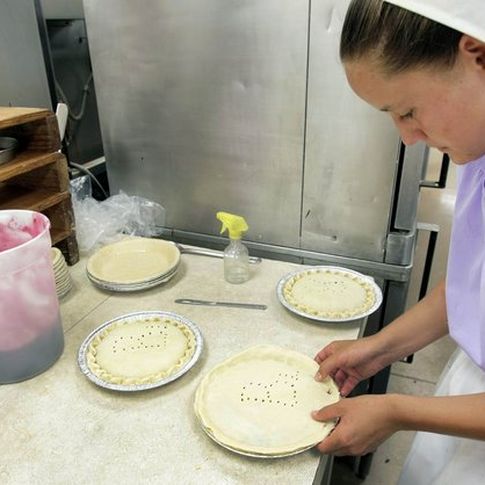 Amish woman preparing fresh baked goods at Nettie Ann's Bakery, part of the Amish Cheese House in Chouteau.
